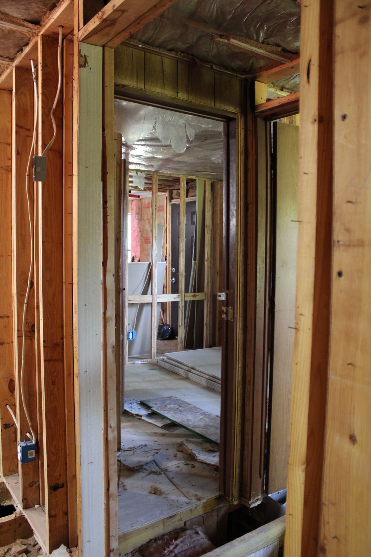 Framed hallway and doorway showing the structure of the renovation