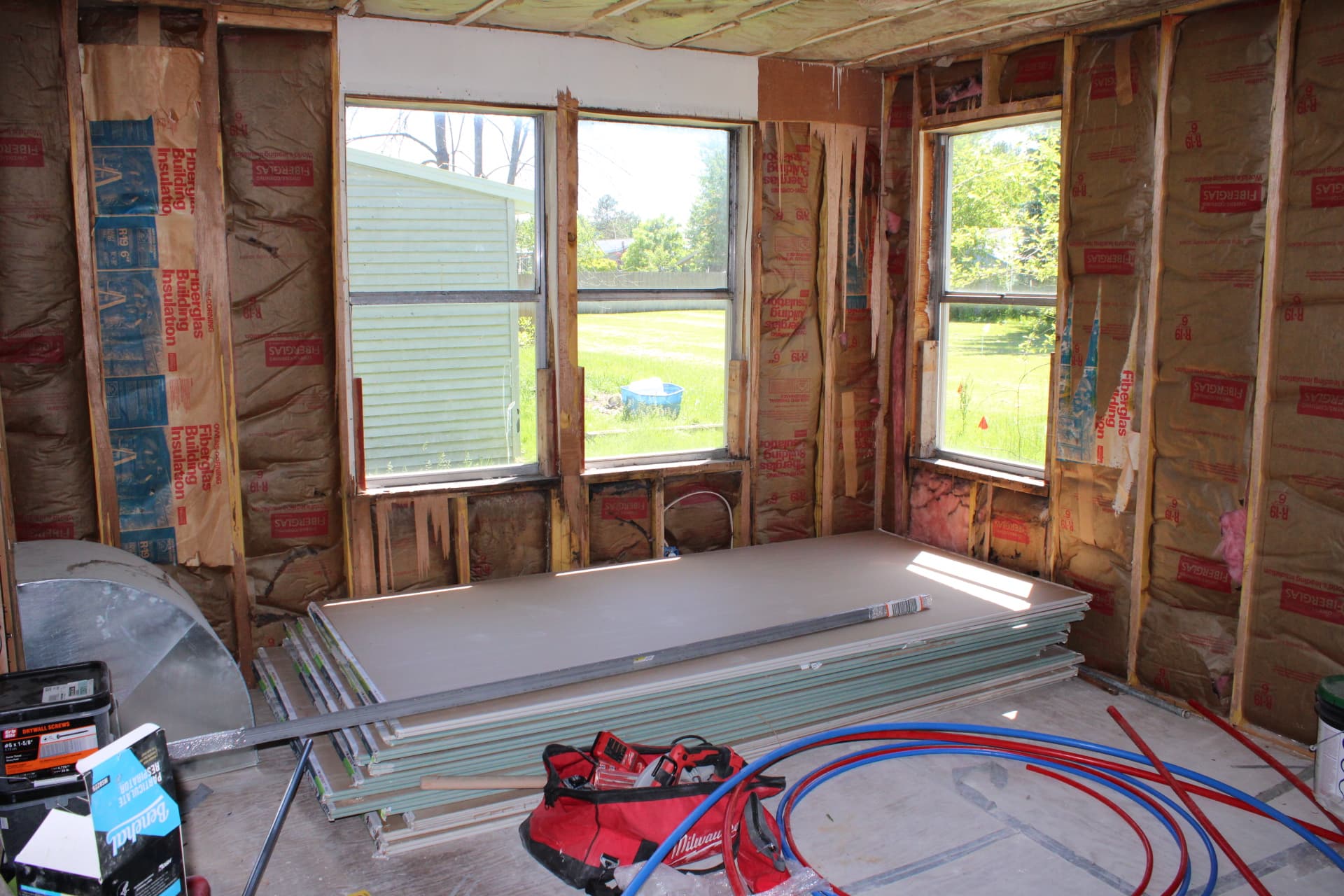 Insulated exterior wall with large windows during renovation